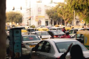 Busy street scene with congested traffic in New Delhi, India. Captured in vibrant daylight showcasing city hustle.